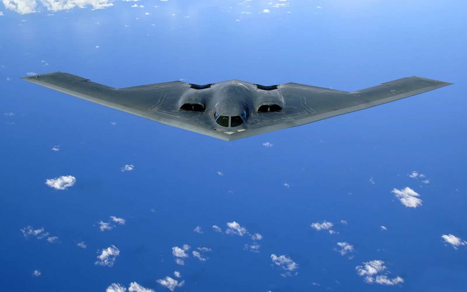 A B-2 Spirit stealth bomber in flight after a refueling mission over the Pacific Ocean